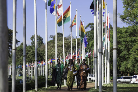 Women along a row of country flags