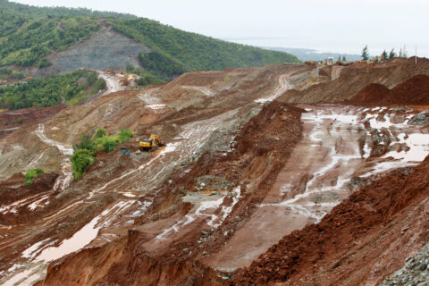 A digger at work on a deforested muddy hill. We need global binding rules for energy-transition mineral extraction