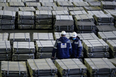 A view shows two workers inspecting nickel sheets in Russia