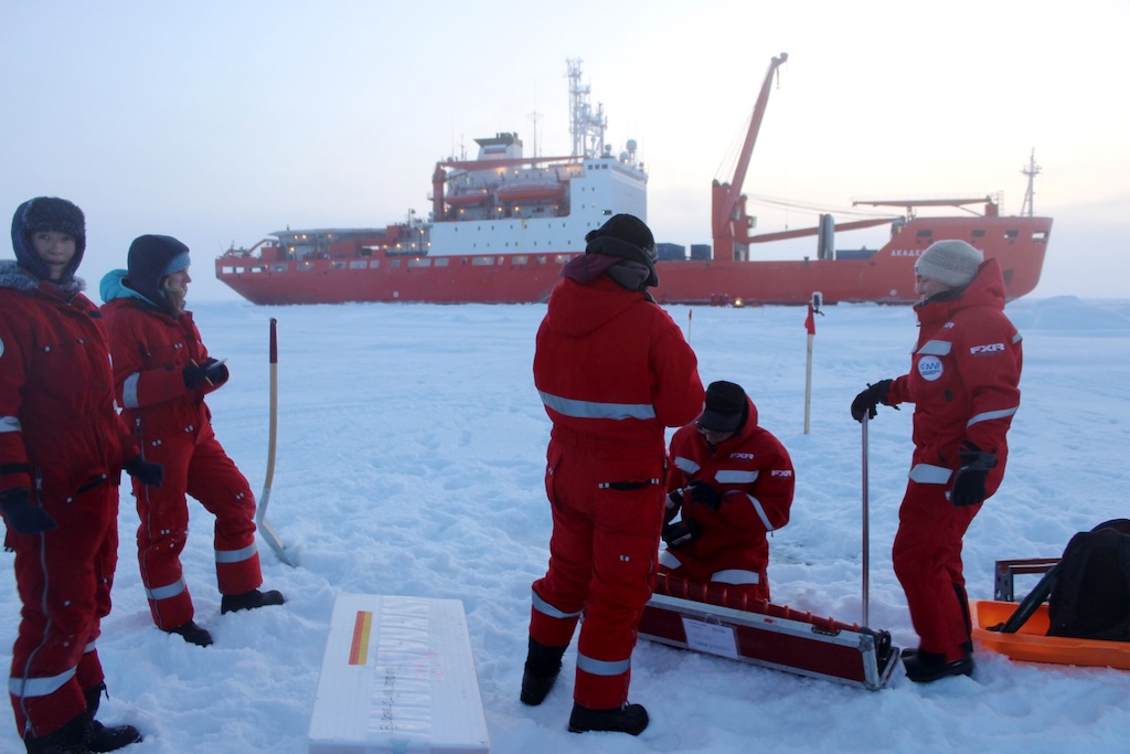 A team of researchers take ice cores in front of the Russian icebreaker Akademik Fedorov during the MOSAiC expedition in 2019. Credit: Daisy Dunne for Carbon Brief