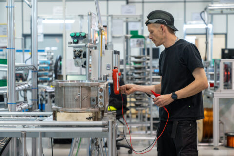 A workman working on an AEM rare earth-free motor in a factory