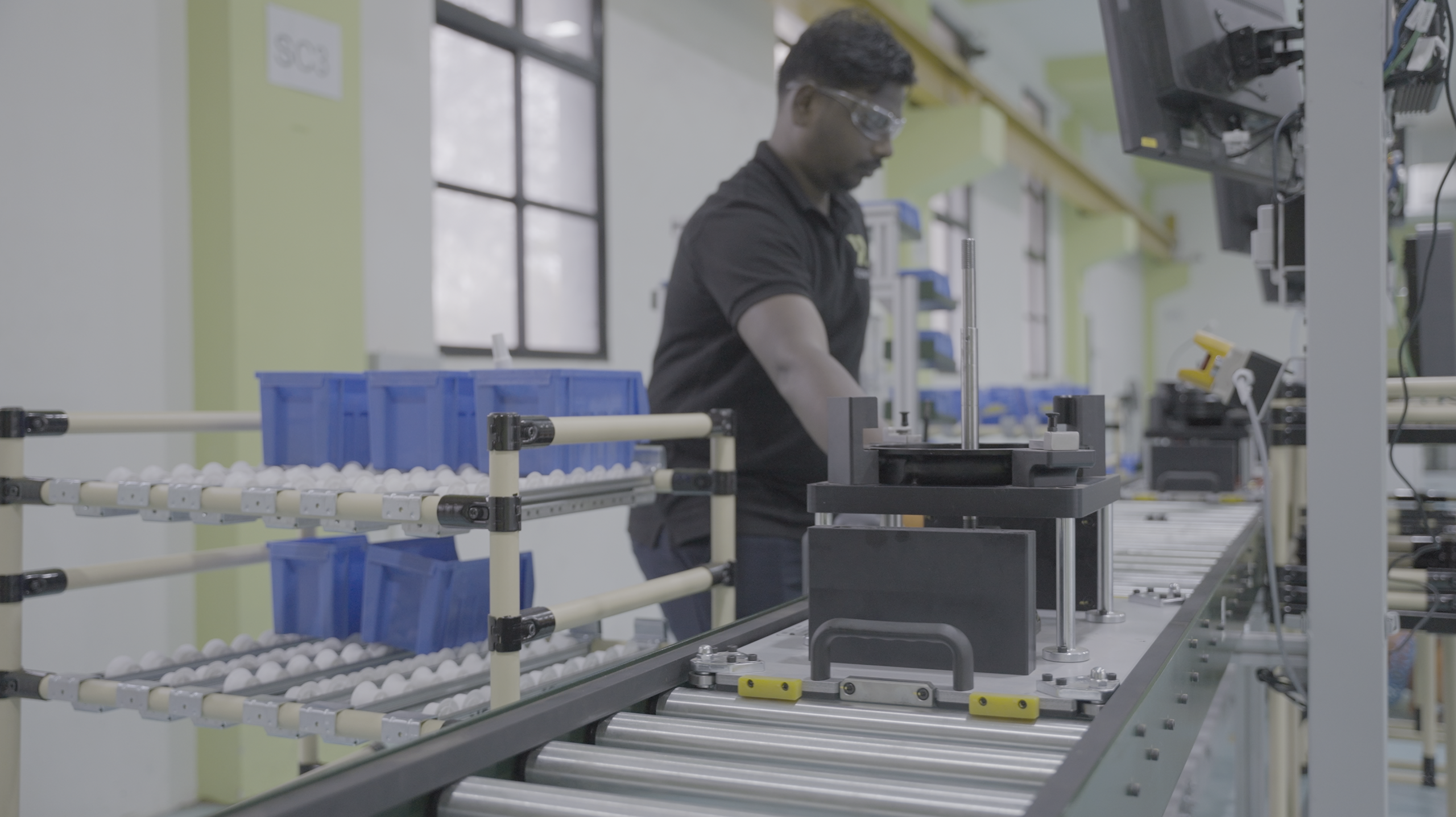 Conifer's motor assembly line with an workman in background