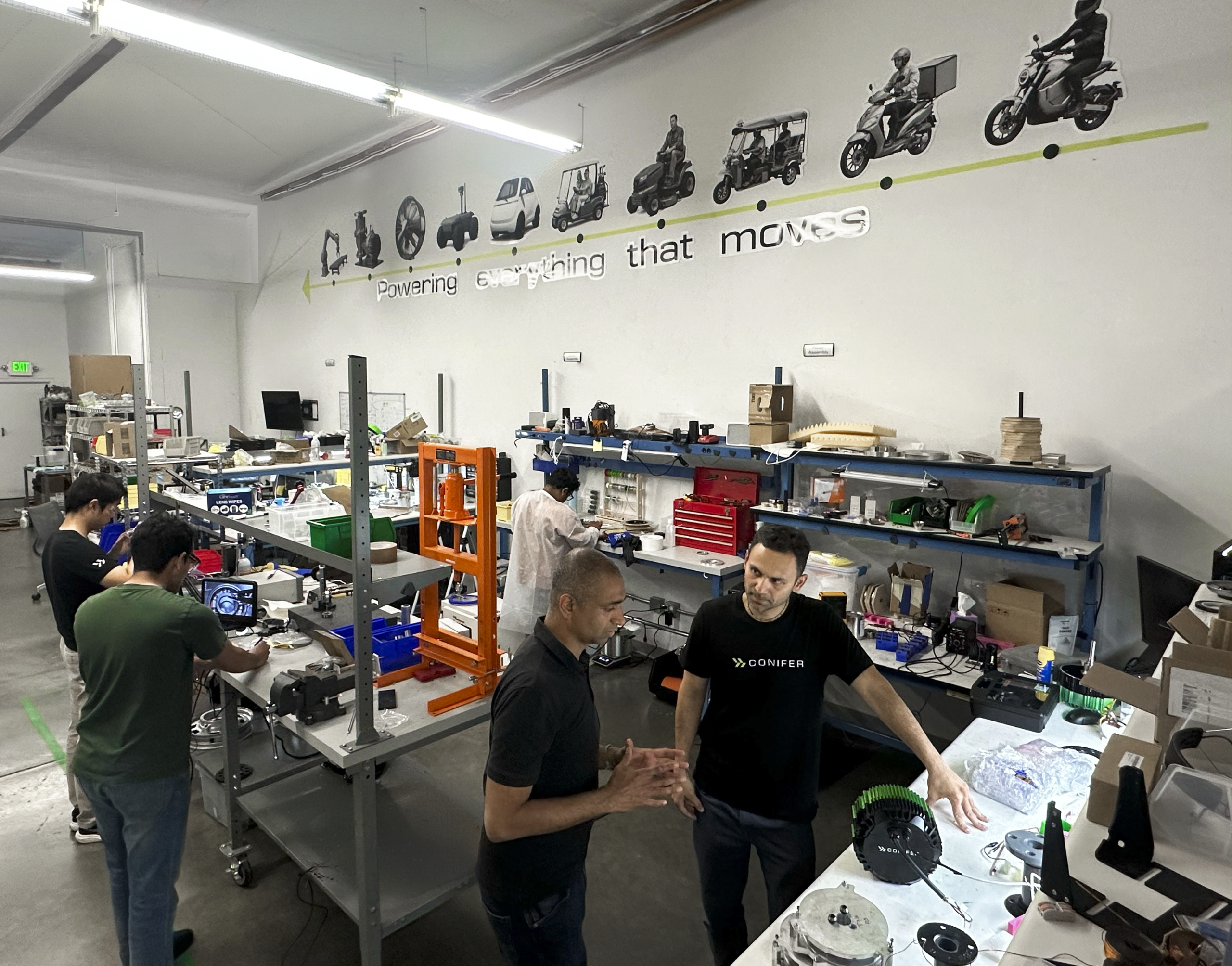 Conifer's Ankit Somani and an employee talk in the firm's R&D facility where staff is working on hardware
