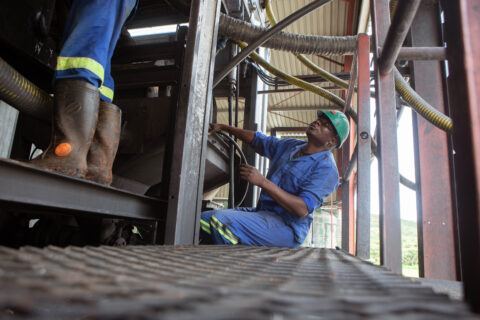Mechanics work on a machine installed at Arcadia Lithium mine in Zimbabwe