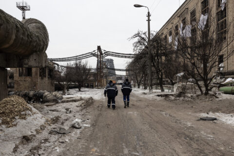 Workers arrive at a power plant that was hit by a Russian attack in Kyiv, Ukraine, in freezing temperatures