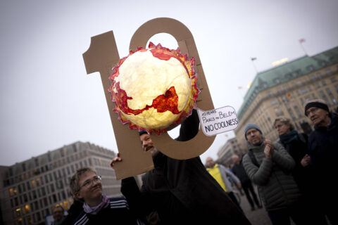 Demonstrators from the Fridays For Future movement with a symbol depicting the Earth burning, 10 years since the Paris Agreement, at a rally coinciding with COP30 in front of the Brandenburg Gate in Berlin, Germany