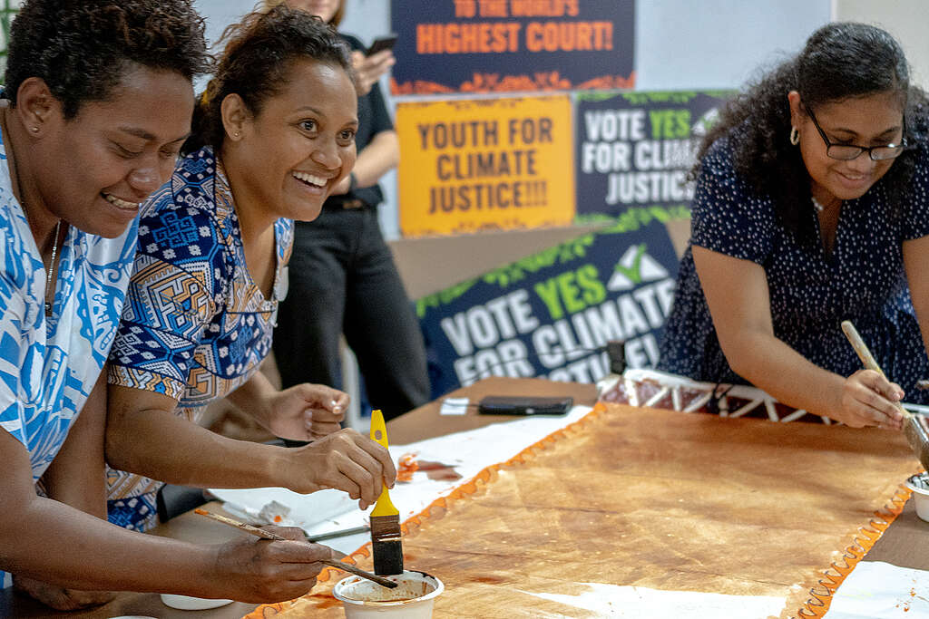 Activists use paint created from dried mangrove flowers to write climate justice messaging and design traditional tapa/masi cloth with motifs from various cultural influences of Fiji.