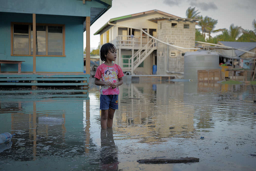 A young Tuvaluan child looking at the after effects of the king tide that hit Funafuti, Tuvalu in February 2023.