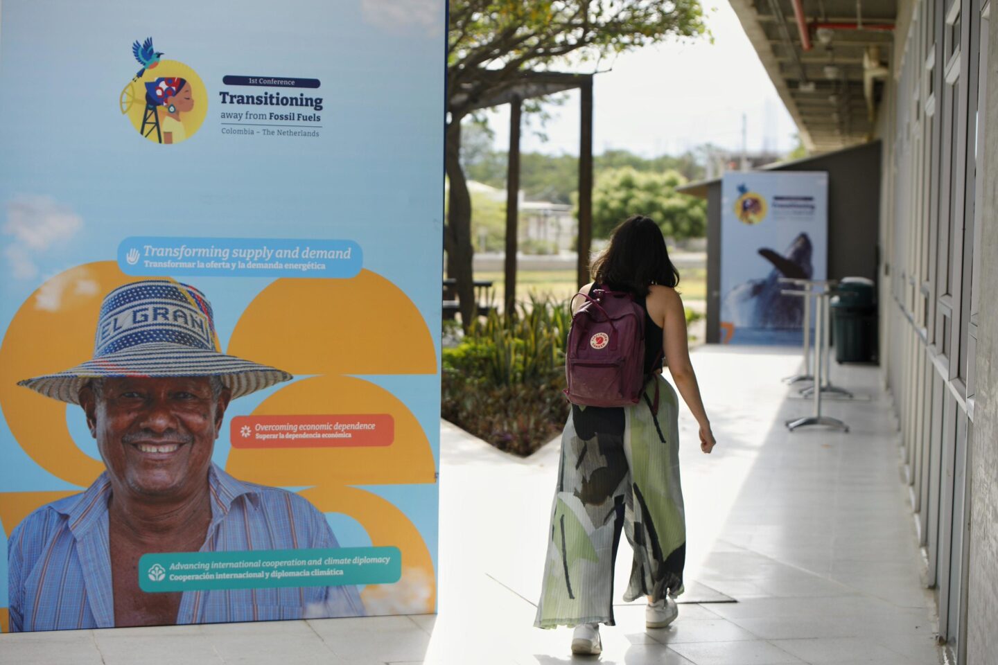 A sign shows the logo and themes of the First Conference on Transitioning Away from Fossil Fuels in Santa Marta, Colombia