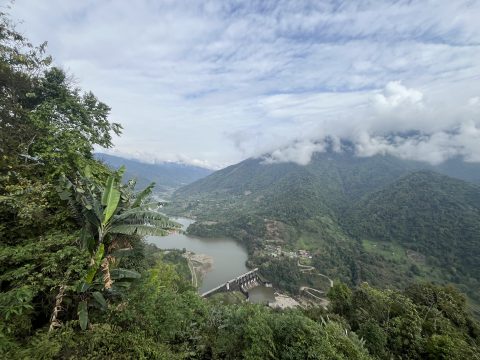 View over a large dam in a lush valley in the Keyi Panyor district, Arunachal Pradesh, India