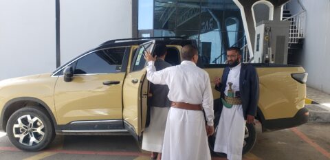 Yemenis charging their large gold-coloured hybrid pickup in an electric charging station in Sanaa