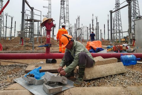 Workers work at the Pho Noi Power Station, a state utility owned by Electricity of Vietnam, in Hung Yen province