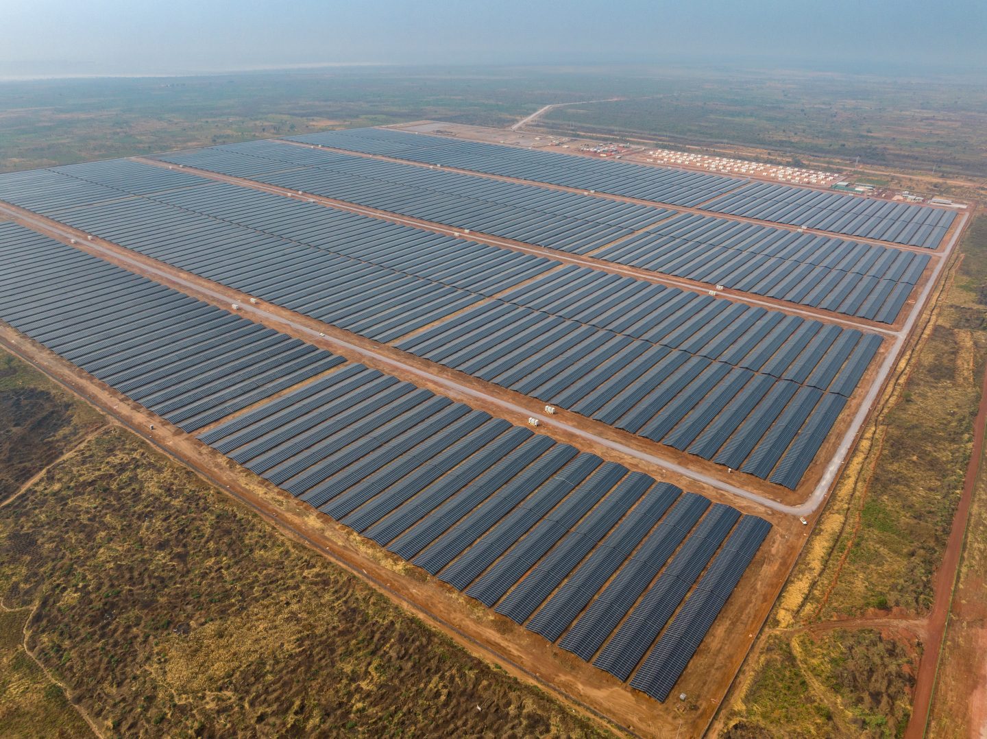 Aerial view of a vast solar park and battery storage containers powering the Kamoa Copper mine in southern DRC