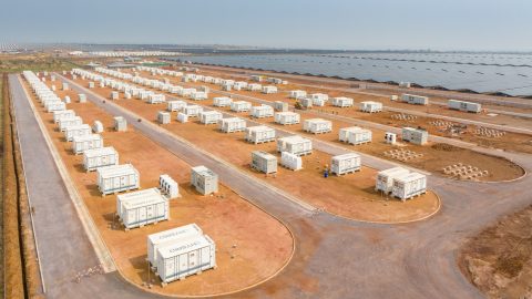 Rows of battery storage containers stand next to solar panels at the Kamoa Copper mine in the DRC