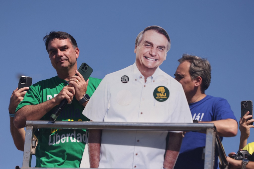 Brazilian presidential candidate Flávio Bolsonaro with a cardboard cutout of his father, former president Jair Bolsonaro