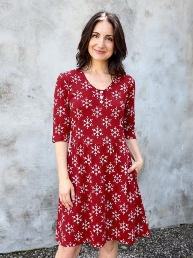 Model wearing snowflake printed organic cotton red dress by Passion Lilie