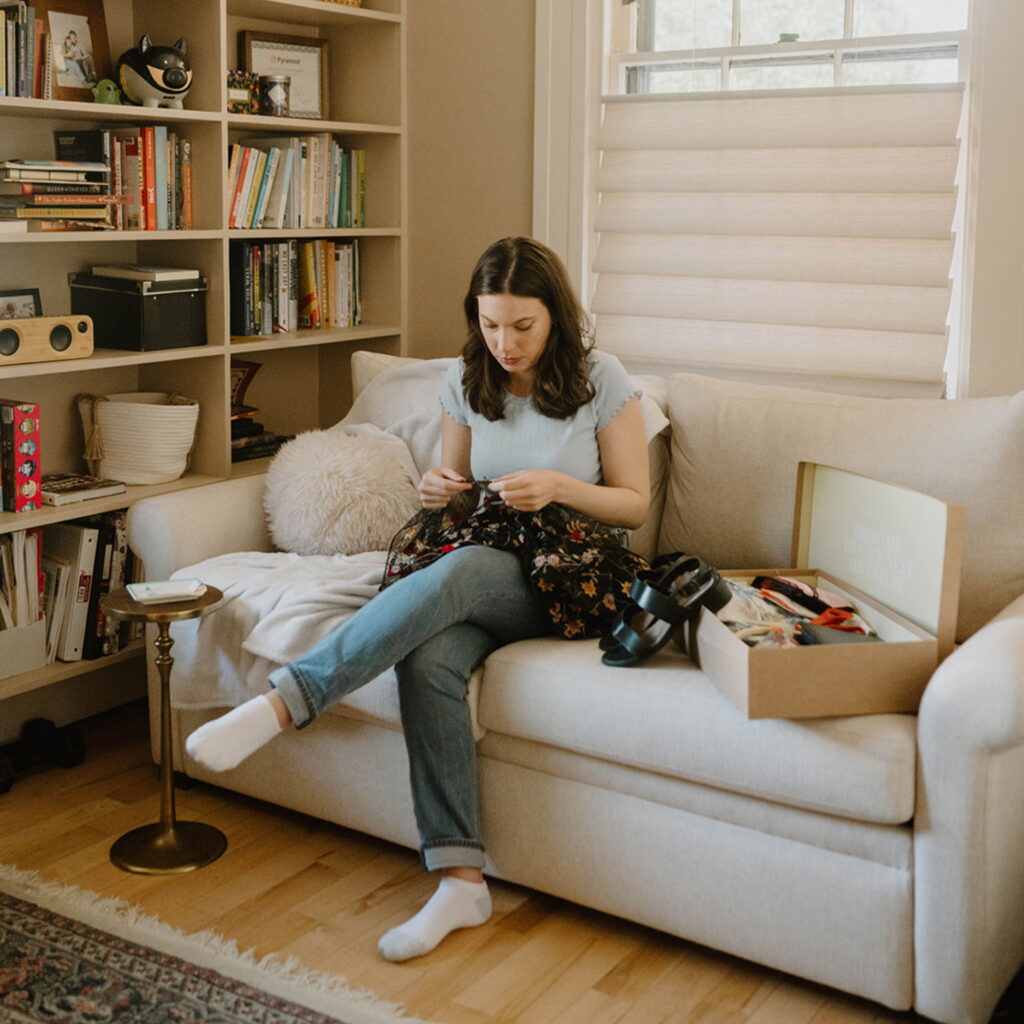 Kathryn Kellogg sitting down with sewing supplies