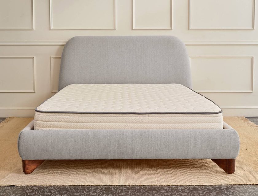 Non-toxic organic mattress on gray upholstered bed