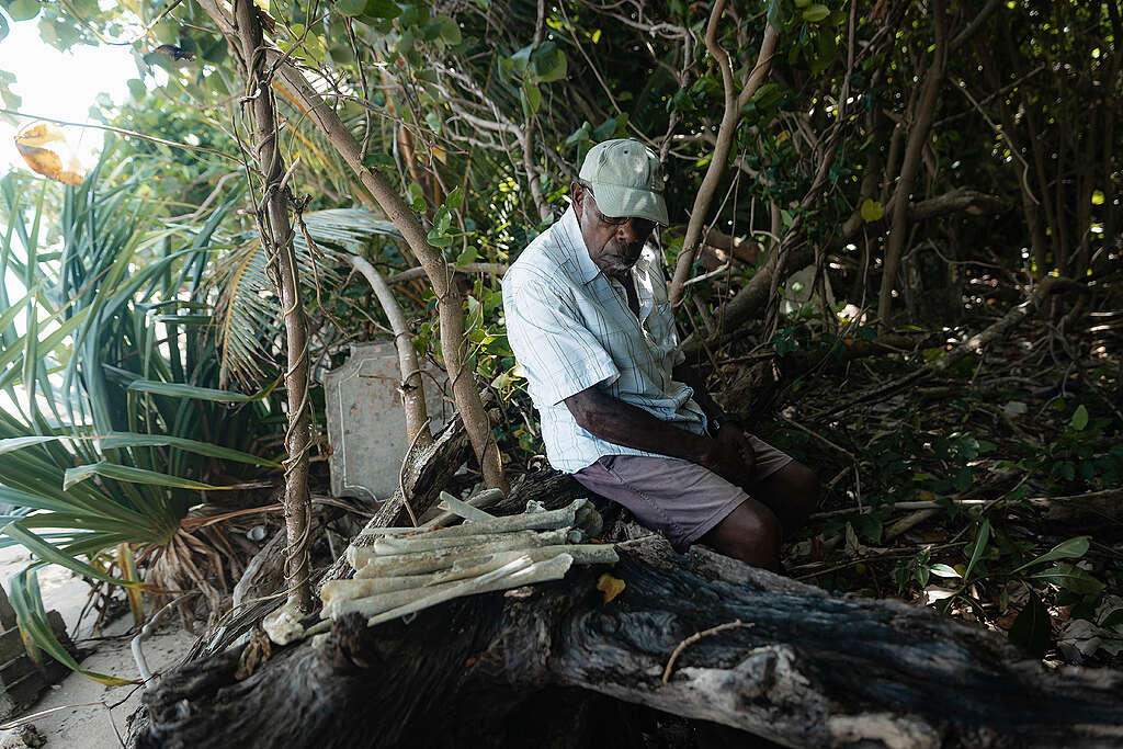 Barry Dick observes the community graveyard impacted by coastal erosion on Pele Island in Vanuatu.