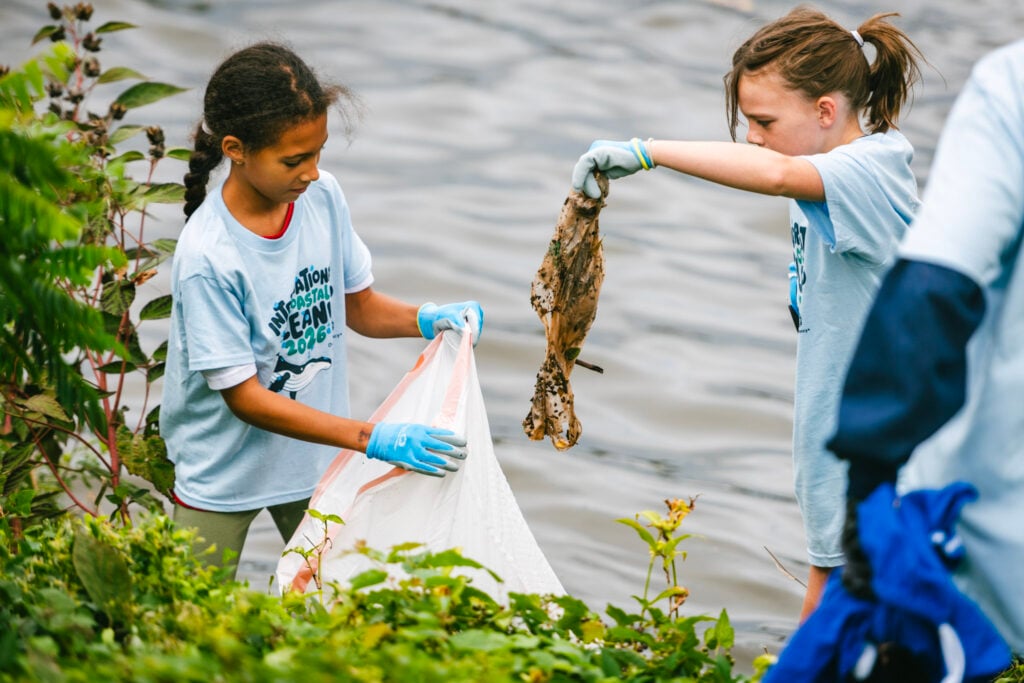 Two young children help collect trash during the 41st annual ICC.