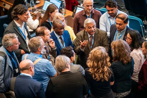 Delegates join a huddle at the 65th meeting of the Intergovernmental Panel on Climate Change